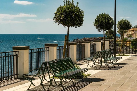 Bench and little trees at the sicilian sea, Italy