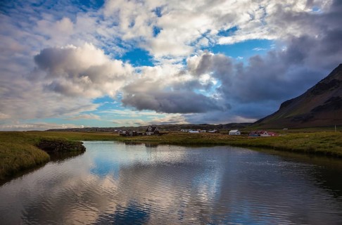 Quiet summer evening on the coast of Iceland. Small pond in the fishing settlement of Arnastapi