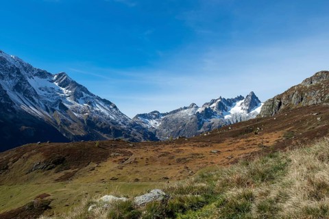 Beautiful autumn landscape in the central Alps, Switzerland. Orange colours and alpine wilderness