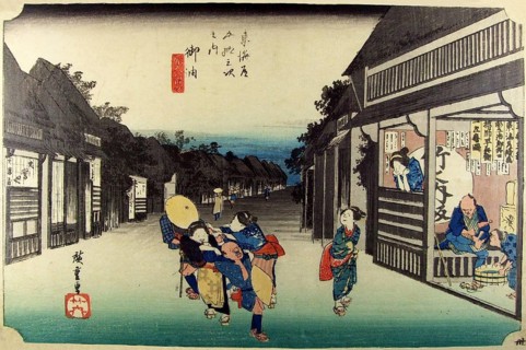 Goyu: Main street of the village at nightfall and female touts dragging travellers into the