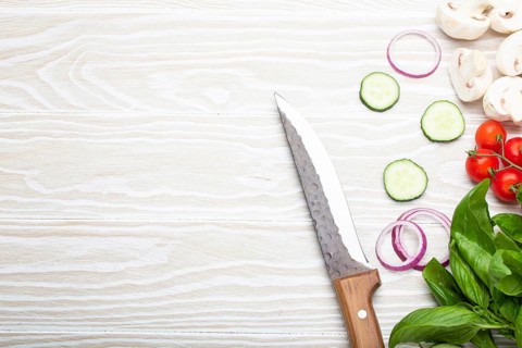 Food cooking background: fresh ingredients with kitchen knife, basil, cherry tomatoes, mushrooms,