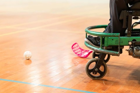 Photo of disabled man on a wheelchair playing sports, hockey, International wheelchair amputee