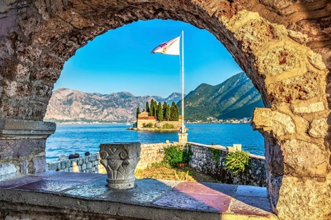 View on St George island from Our Lady of the Rocks through arch. Perast, Montenegro