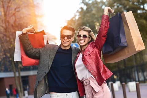 Portrait of a couple with shopping bags in the city.People, sale, love and happiness concept
