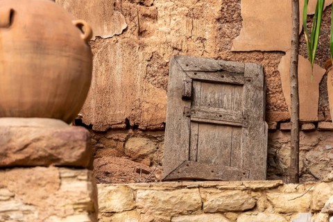 Beautiful old window shutter leaning at a facadeof a house in Agadir, Morocco