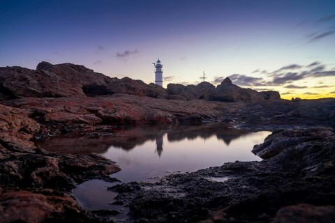 A long exposure view of the Cap de ses Salines Lighthouse on Mallorca at sunrise