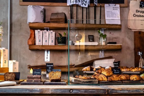 Madrid, Spain, October 17, 2020: Interior of hipster cafe with fresh bakery on counter