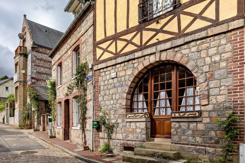 Charming stone and half-timbered houses with large windows in an old street, The historic mill