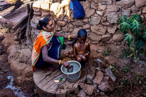Mother bathing child, Araku, Andhra Pradesh, India, Asia
