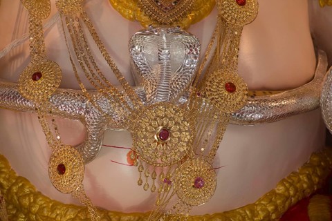 Snake made by silver around belly of Lord Ganesha, Pune, Maharashtra, India, Asia