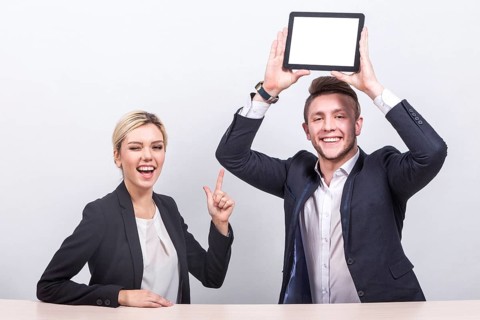 Attractive young caucasian businesswoman with ponytail in black suit and businessman in black suit