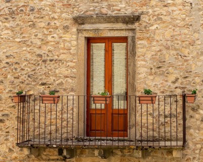 The window and the balcony of an ancient Sicilian medieval house