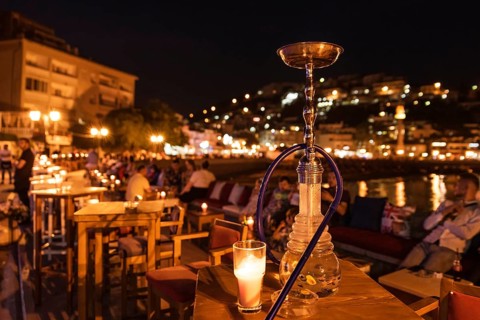 Shisha on the table in restaurant, in the background city Ulcinj in Montenegro at night.