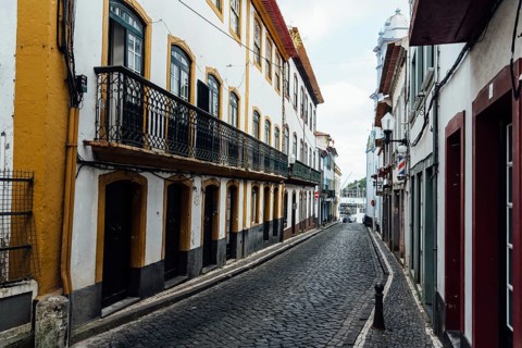 Angra do Heroismo, Portugal, July 1, 2022: Street with Traditional colonial houses painted in