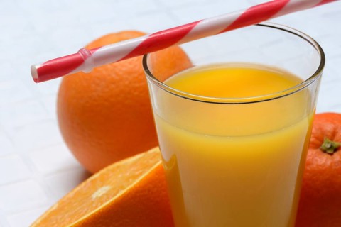 Orange juice in glass and orange
