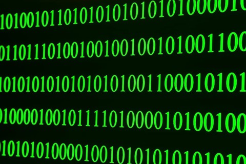 Green binary code in clear rows on a black background