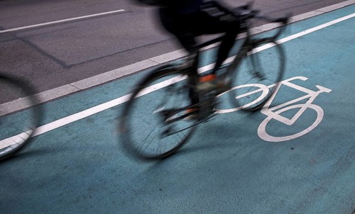Bicycle, cyclist, rides on cycle path, pictogram, logo, labelling, next to road, movement effect,