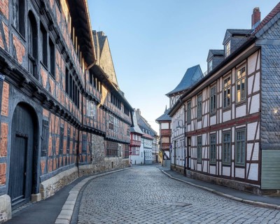 Alley with half-timbered houses and cobblestones in the historic old town, on the left the Siemens