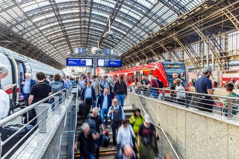 Cologne Central Station. Stairs to the platforms. Travellers waiting for their train on the