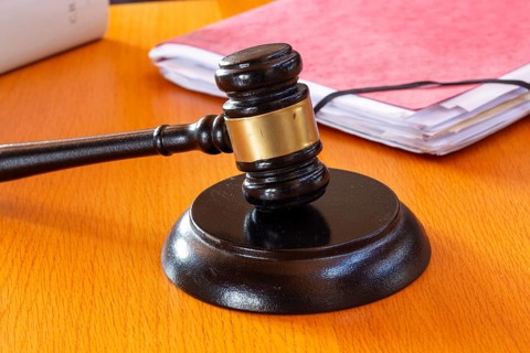 Symbolic image of a court hearing: close-up of a judge's gavel