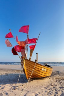 Traditional wooden fishing boat on the beach along the Baltic Sea at Stubbenfelde, Loddin on the