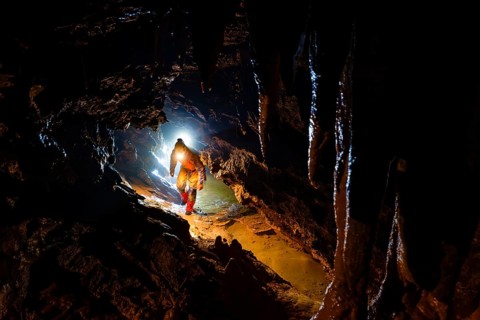 Speleologists climbing through a passage, Advent Cave, Schneizlreuth, Berchtesgadener Land, Upper