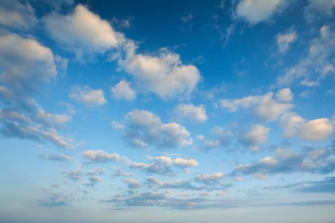 Fleecy clouds adorn the blue evening sky