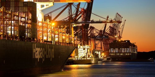 Container ships at the Eurogate container terminal in the evening with an atmospheric sunset,