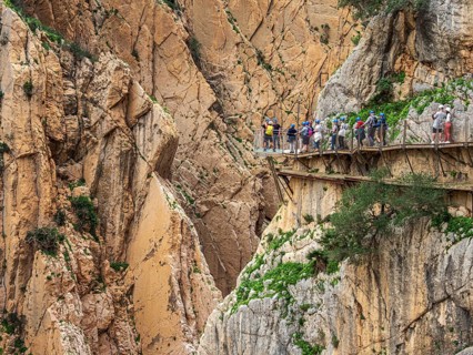 Tourists on the elevated path of the caminito del rey, along a deep gorge, Andalusia, Spain