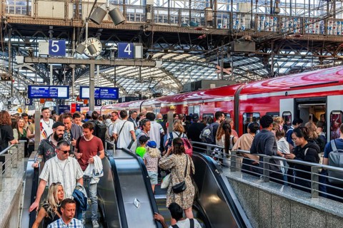 Cologne Central Station. Stairs to the platforms. Travellers waiting for their train on the