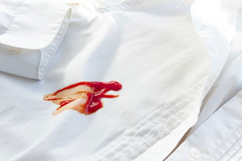 White shirt stained with ketchup, no people, close-up, selective focus