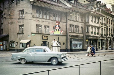 Chevrolet car passes a policeman directing traffic in the city of Bern, Switzerland, Europe 1961