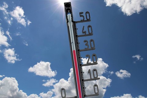 (Photomontage) Symbolic image of heat: thermometer in front of a summer sky