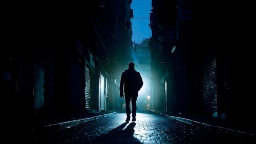 Man fleeing down a narrow dimly lit alleyway urban setting at nighttime, AI generated