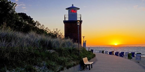 Olhörn lighthouse at colourful sunrise over the sea on the North Frisian island of Föhr,