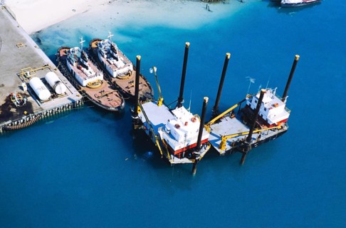 Oil industry in the Ras Tanura area, Saudi Arabia, tugs moored to platforms, 1979