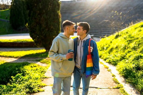 Romantic gay couple enjoying a sunny day in the park, sharing tender moments of love and affection