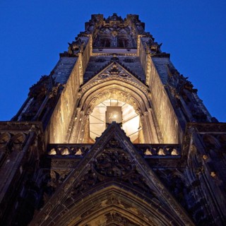 Illuminated church tower of the St. Nikolai memorial, ruins of the former main church of St.