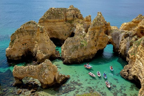 Excursion boats on the rocky coast near Lagos, Algarve, Portugal