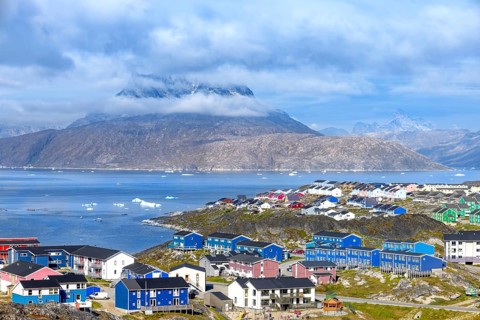 Panoramic view of Greenland capital Nuuk with colored houses located near fjords and icebergs