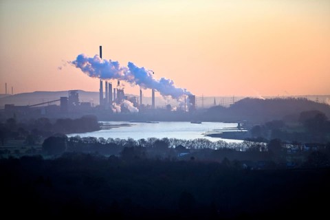 View in front of sunrise from the Rheinpreussen spoil tip onto the Rhine in Duisburg with the