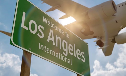 Welcome to los angeles international airport green road sign with airplane above