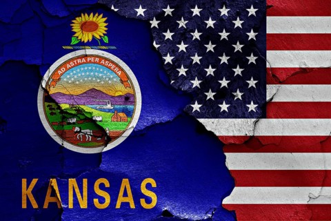 Flags of Kansas and USA painted on cracked wall