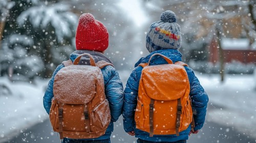 Two school boys in winter attire walk through a snowy landscape wearing backpacks, AI generated