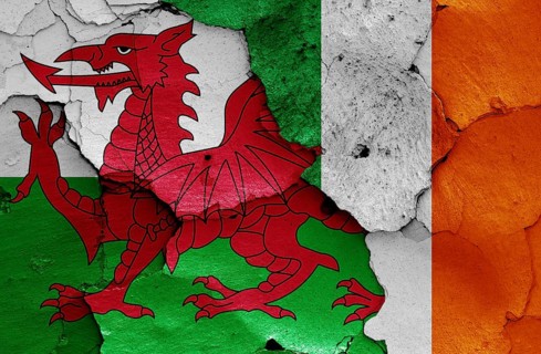 Flags of Wales and Ireland painted on cracked wall
