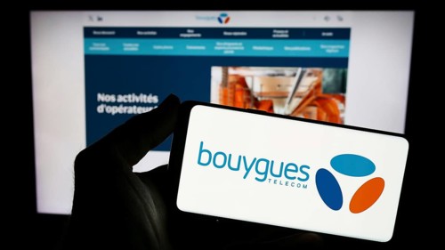 Stuttgart, Germany, 11-22-2023: Person holding smartphone with logo of French telecommunications