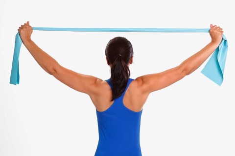 Woman doing sports exercise with Thera-Band, sports exercises