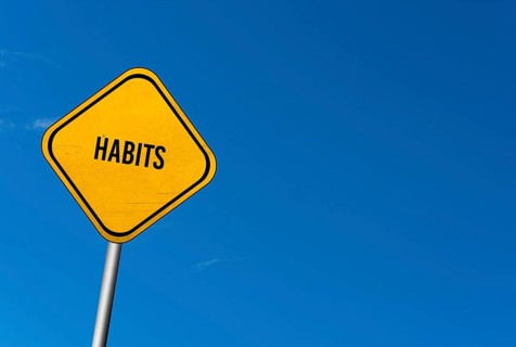 Habits, yellow sign with blue sky