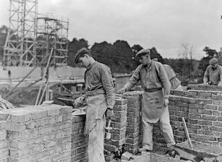 Builders in the 1940s. Two men are laying a brick wall. Sweden 1940s
