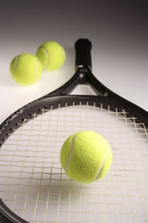 Tennis balls three green color with tennis racket racquet